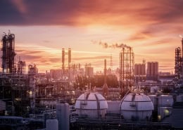 Gas storage sphere tanks in petrochemical industry or oil and gas refinery plant at evening, Manufacturing of petroleum industrial plant with gas column and smoke stacks on sunset sky background